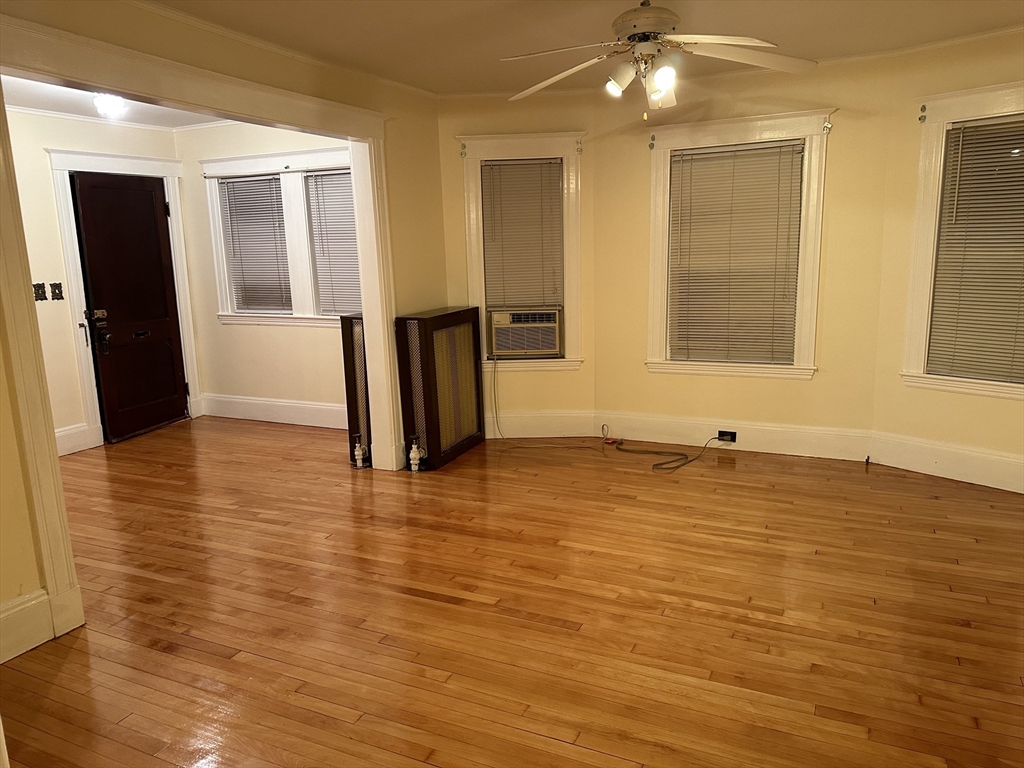 158 Hillside Road, Unit 1 Watertown, MA 02472 - Photo 4 of 10 a view of a room with wooden floor and a large window