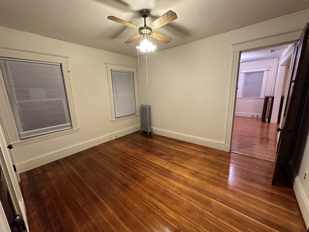 158 Hillside Road, Unit 1 Watertown, MA 02472 - Photo 8 of 10 a view of empty room with wooden floor and fan