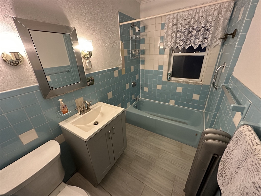 158 Hillside Road, Unit 1 Watertown, MA 02472 - Photo 10 of 10 a bathroom with a sink mirror and toilet