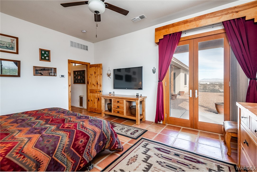 1830 Egar Road Golden Valley, AZ 86413 - Photo 26 of 84 a bedroom with a bed and a flat screen tv