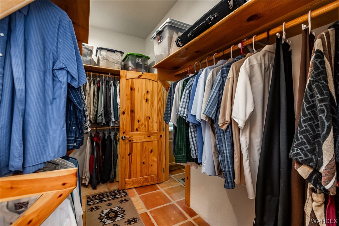 1830 Egar Road Golden Valley, AZ 86413 - Photo 29 of 84 a view of walk in closet with clothes and shoes