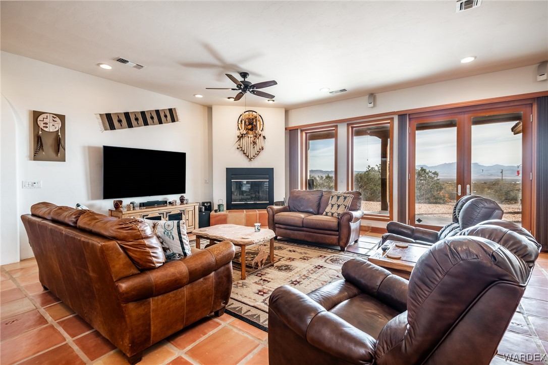 1830 Egar Road Golden Valley, AZ 86413 - Photo 4 of 84 a living room with furniture a flat screen tv and a large window