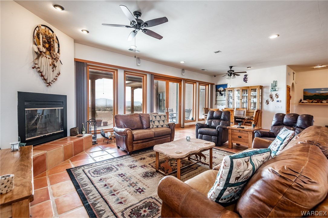1830 Egar Road Golden Valley, AZ 86413 - Photo 5 of 84 a living room with furniture a rug and a flat screen tv