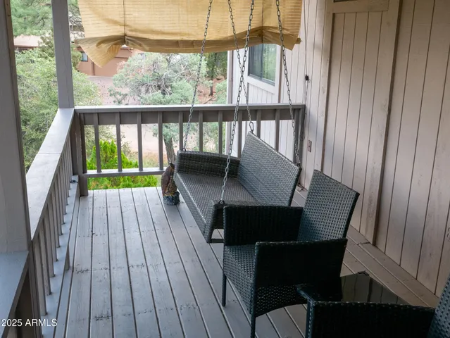 a view of a patio with table and chairs under an umbrella