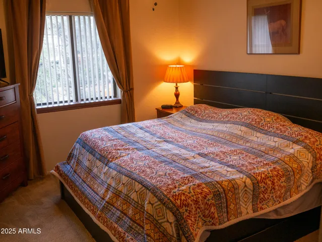a view of a balcony with chair and the garden