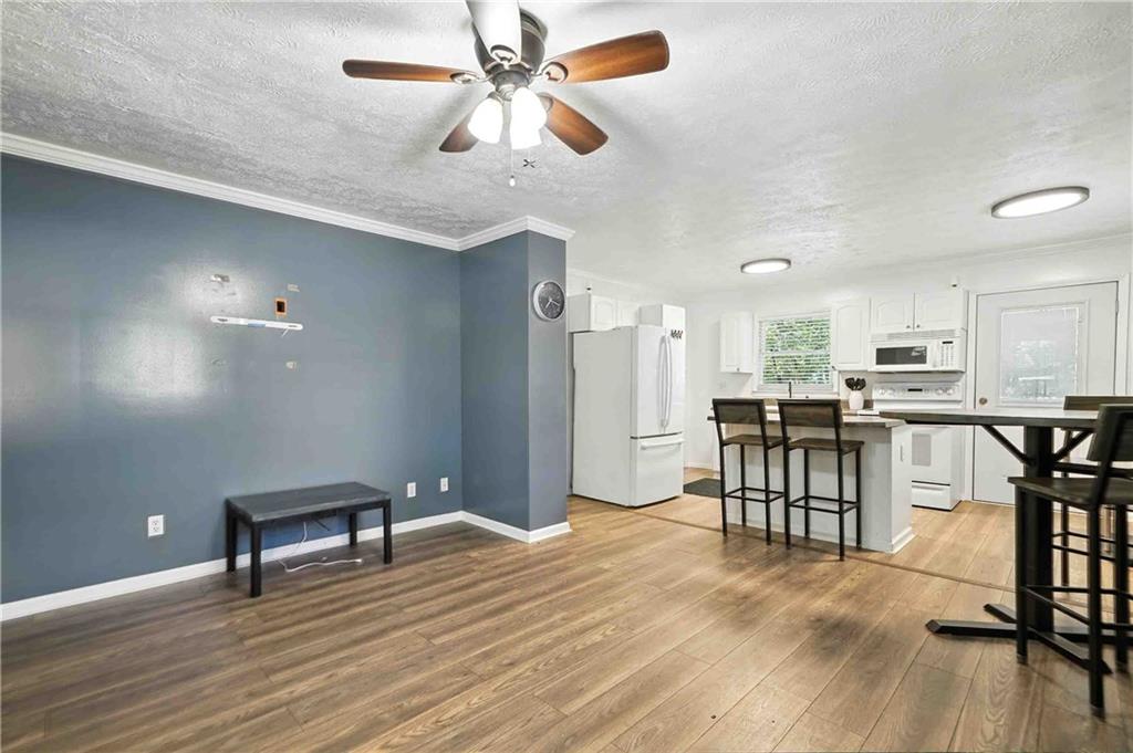 550 Donahoo Road Southeast Silver Creek, GA 30173 - Photo 11 of 29 a view of a dining room with furniture and a wooden floor