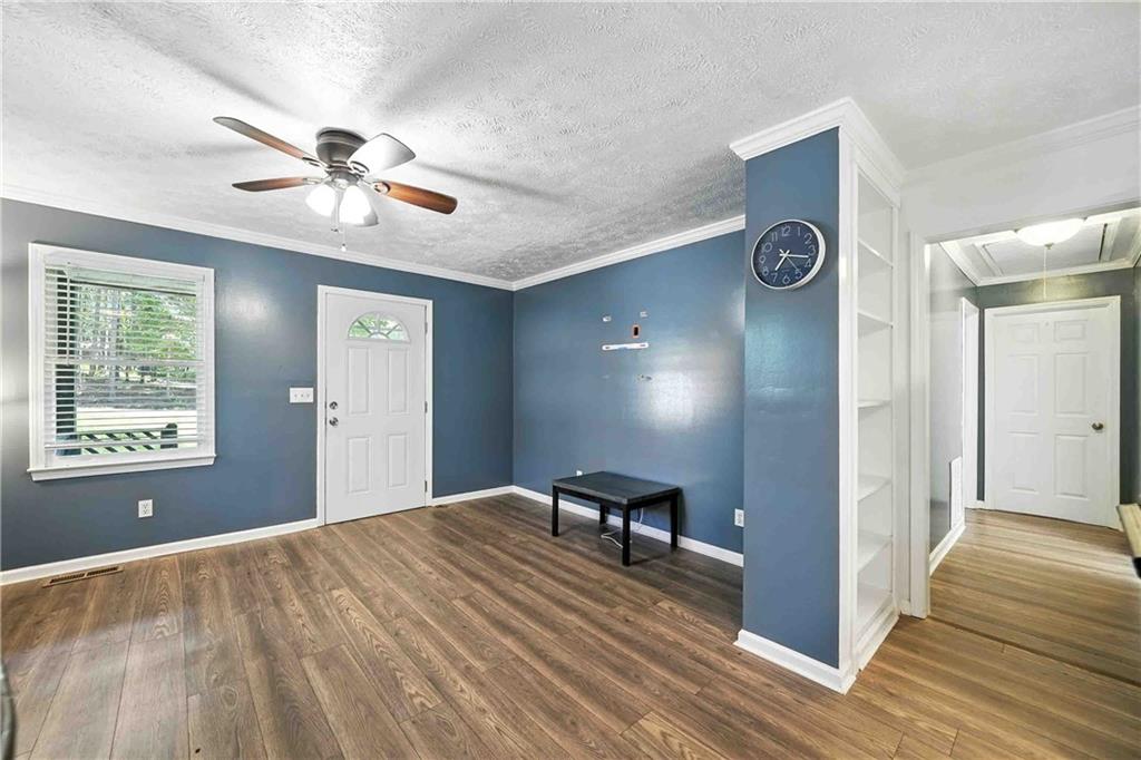 550 Donahoo Road Southeast Silver Creek, GA 30173 - Photo 14 of 29 a view of an empty room with window and wooden floor