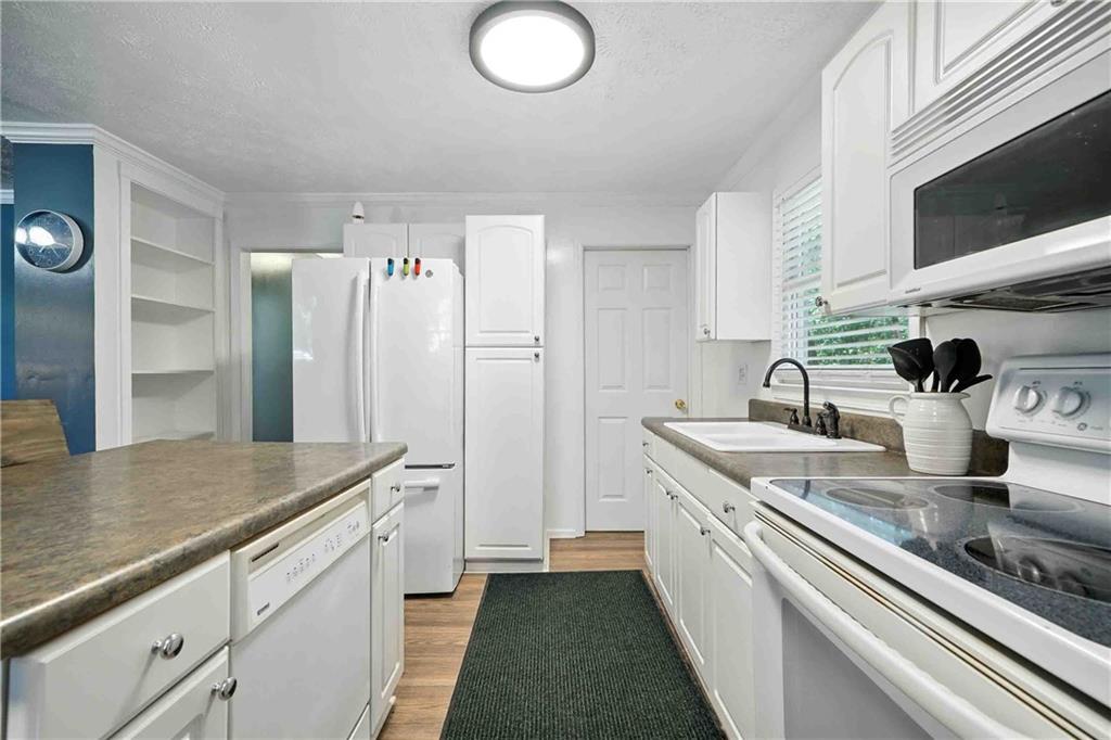 550 Donahoo Road Southeast Silver Creek, GA 30173 - Photo 17 of 29 a kitchen with a sink and refrigerator