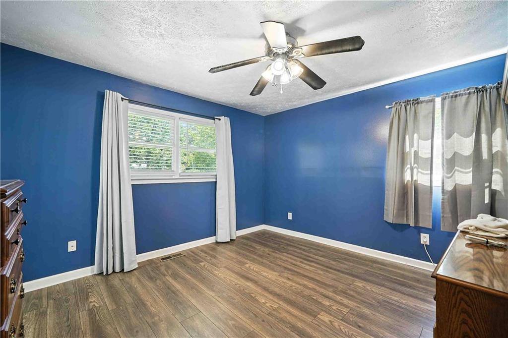 550 Donahoo Road Southeast Silver Creek, GA 30173 - Photo 23 of 29 a bedroom with a large bed and a chandelier