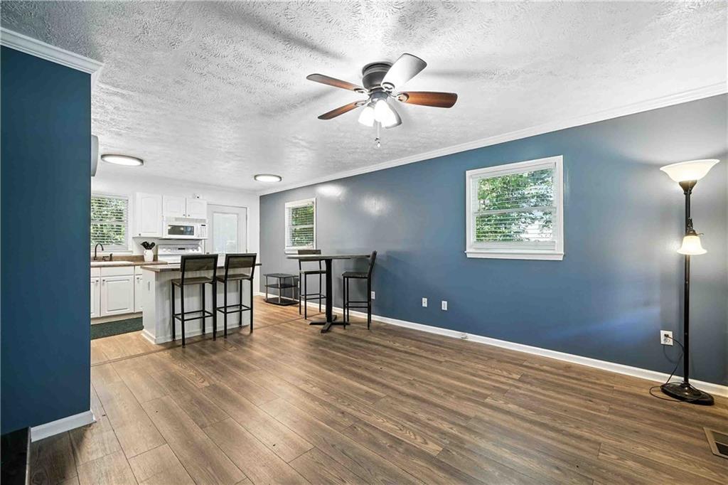 550 Donahoo Road Southeast Silver Creek, GA 30173 - Photo 9 of 29 a view of a workspace with furniture and a kitchen