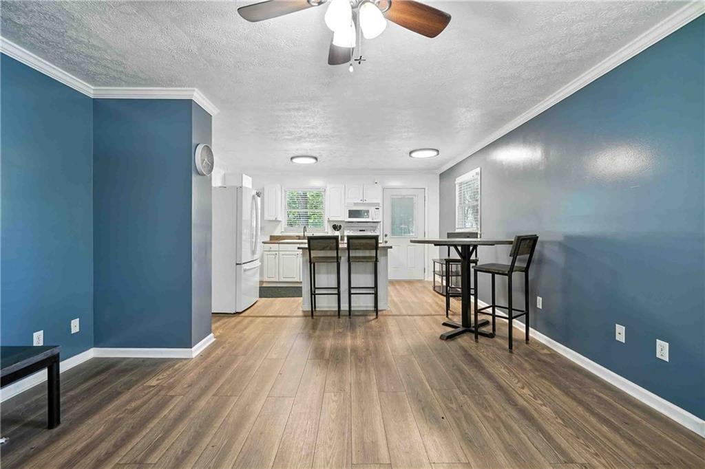 550 Donahoo Road Southeast Silver Creek, GA 30173 - Photo 10 of 29 a view of a kitchen with dining room and wooden floor