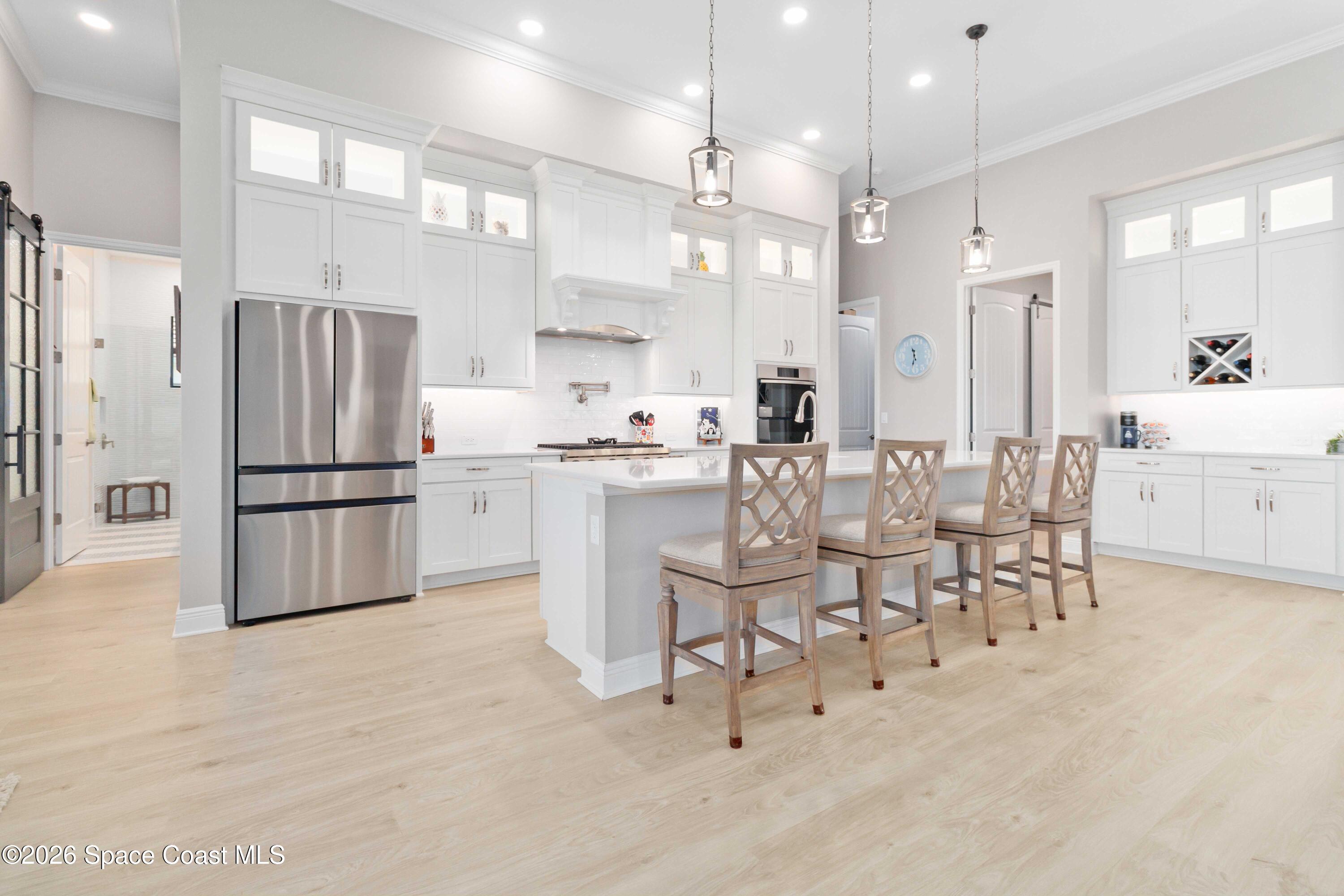 4100 Domain Court Melbourne, FL 32934 - Photo 20 of 52 a kitchen with stainless steel appliances a refrigerator and a dining table