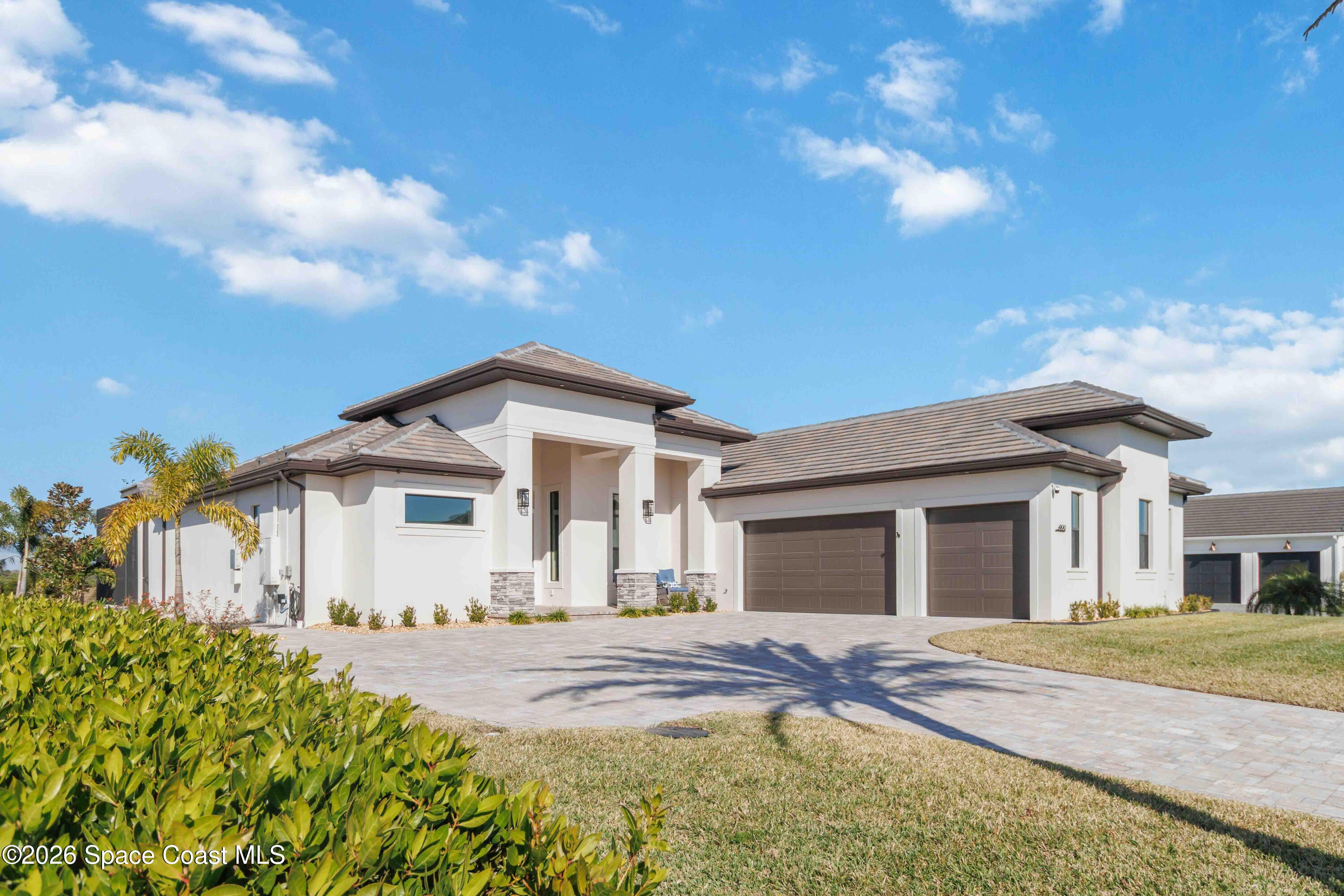 4100 Domain Court Melbourne, FL 32934 - Photo 2 of 52 a front view of a house with a garden