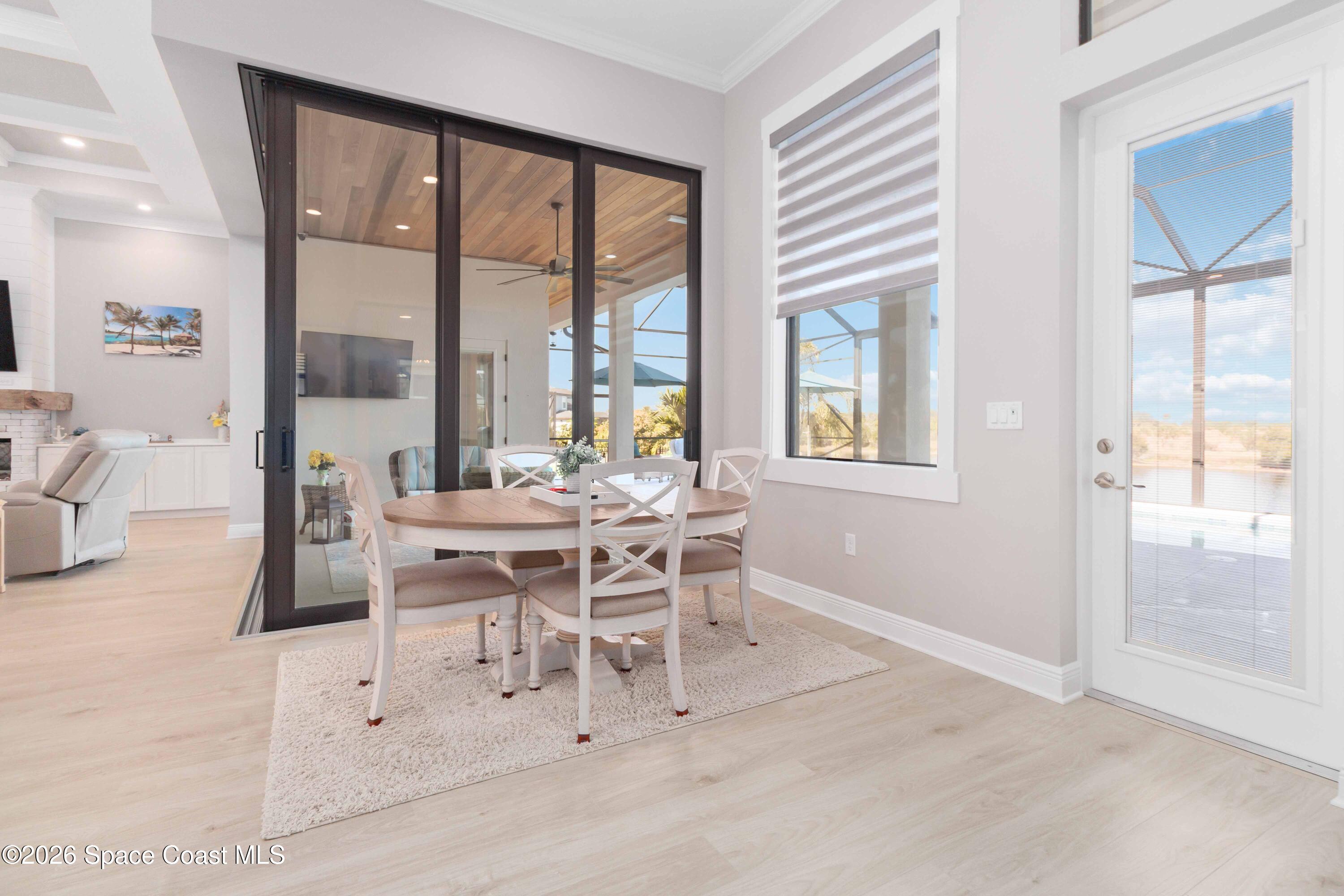 4100 Domain Court Melbourne, FL 32934 - Photo 22 of 52 a dining room with furniture and a large window