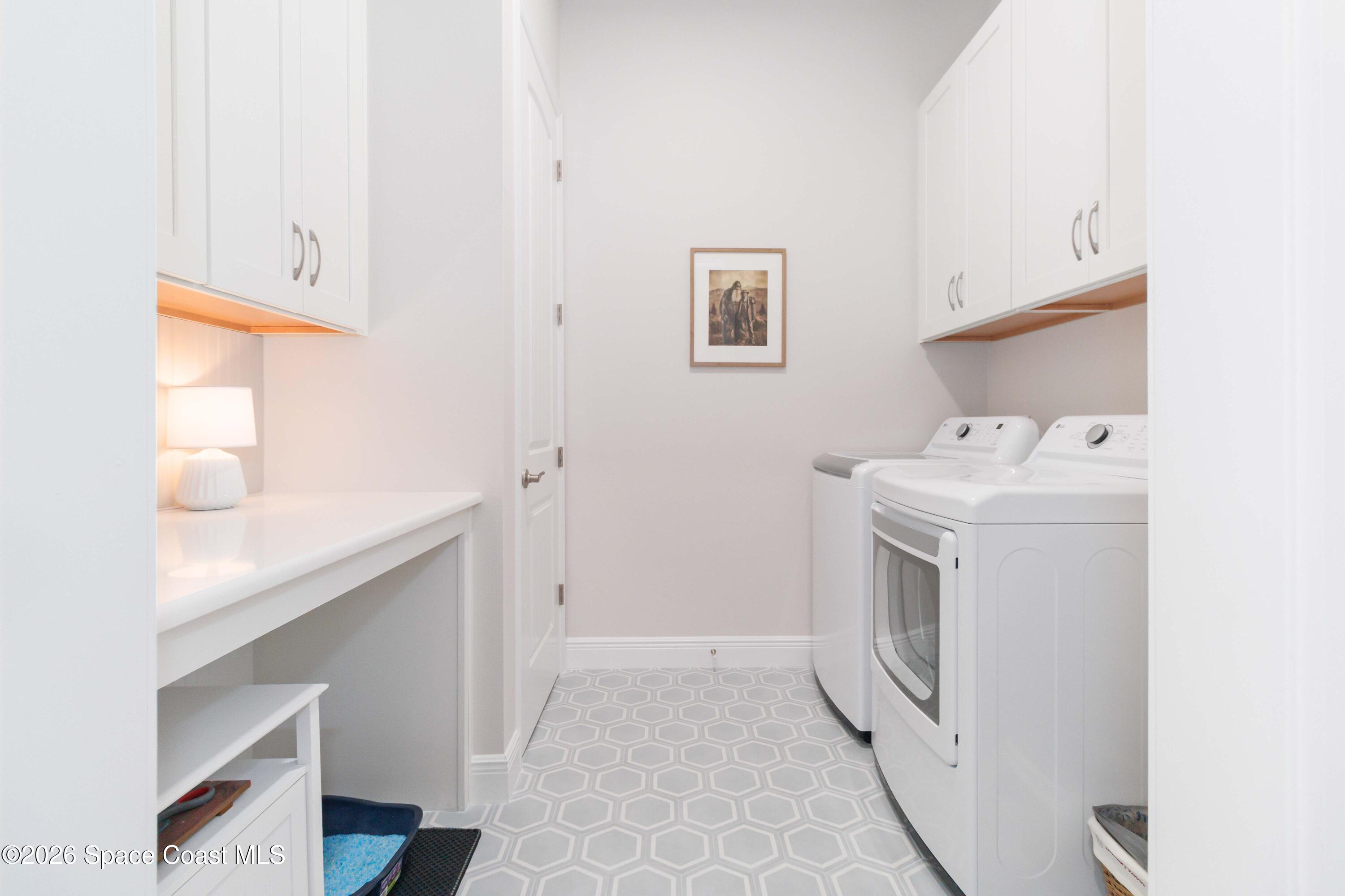 4100 Domain Court Melbourne, FL 32934 - Photo 25 of 52 a utility room with cabinets washer and dryer