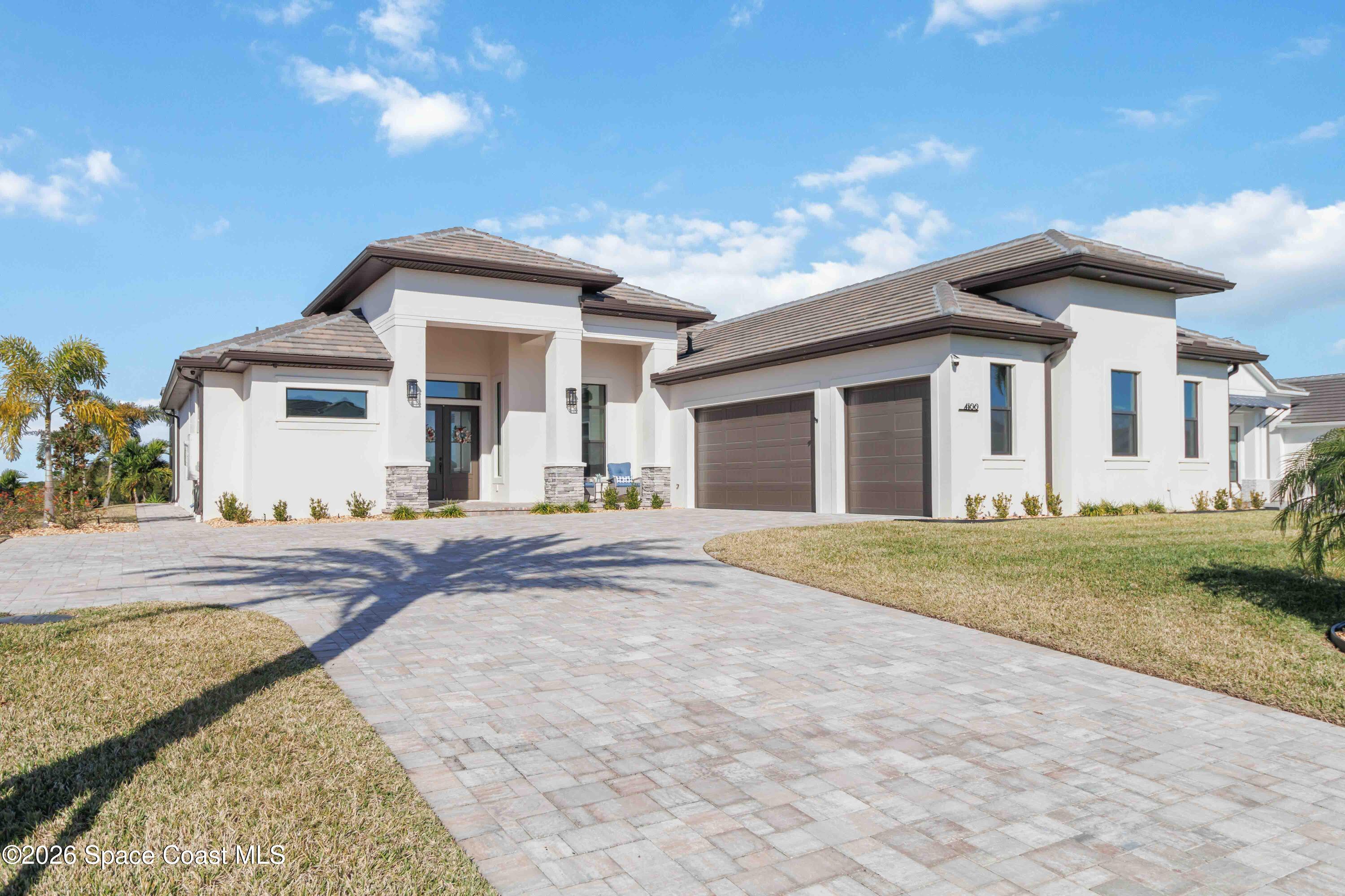 4100 Domain Court Melbourne, FL 32934 - Photo 3 of 52 a view of a white house with a yard and large tree