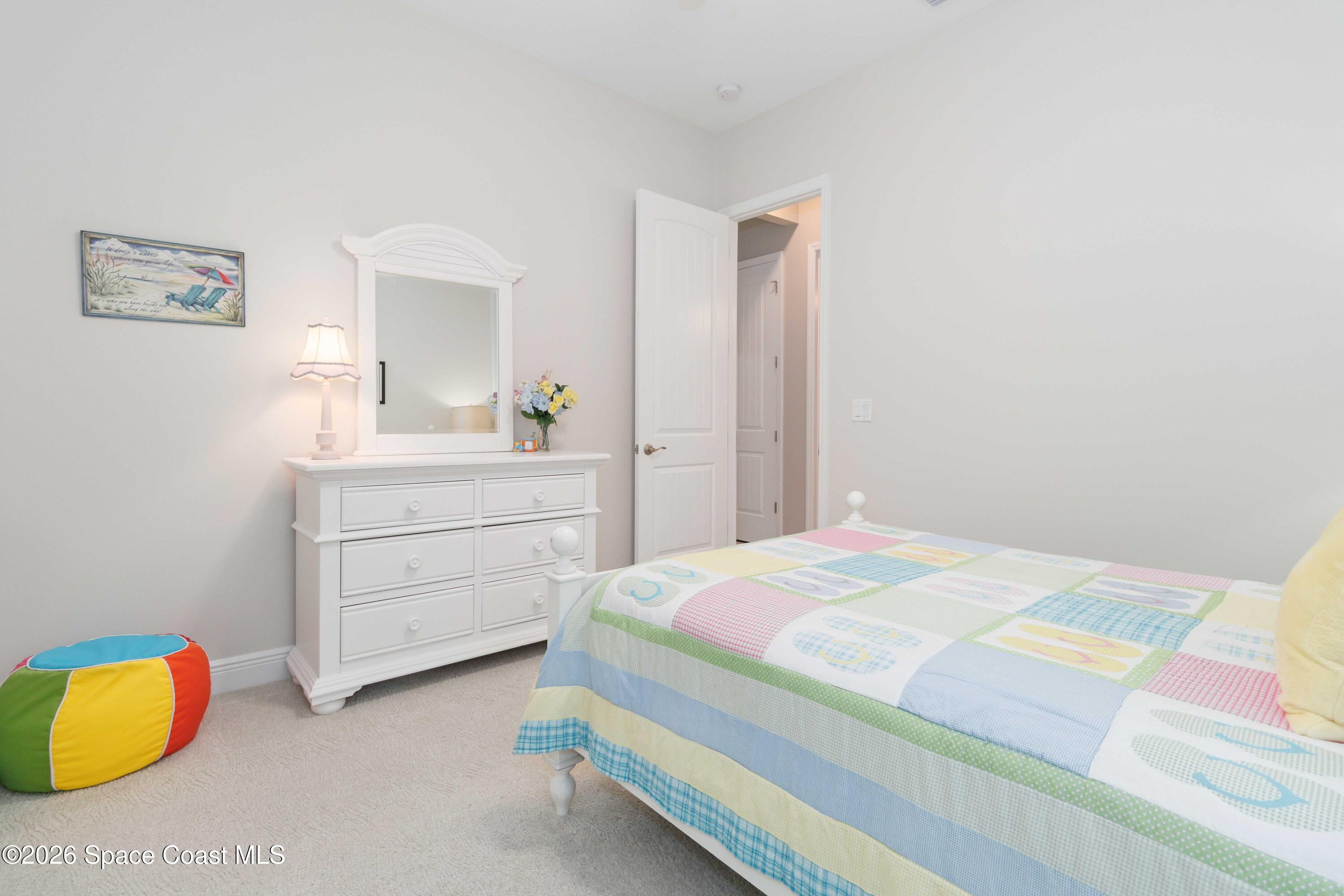 4100 Domain Court Melbourne, FL 32934 - Photo 32 of 52 a bedroom with a bed and a dresser