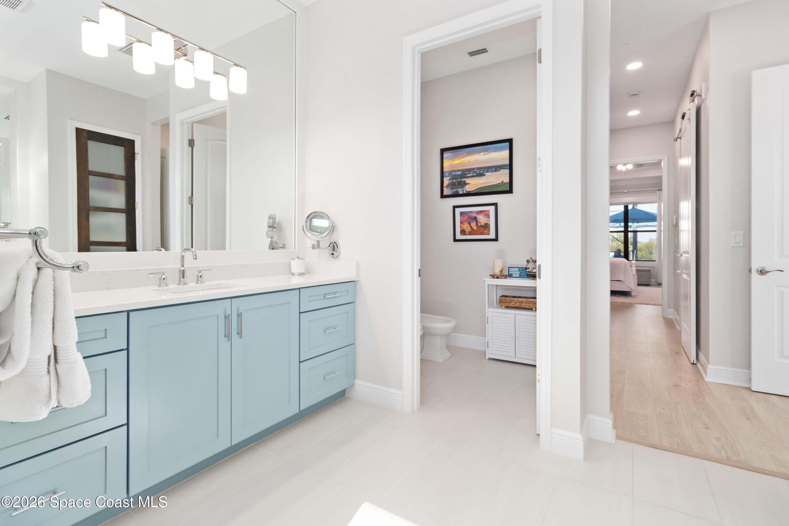 4100 Domain Court Melbourne, FL 32934 - Photo 38 of 52 a spacious bathroom with a granite countertop sink mirror and shower