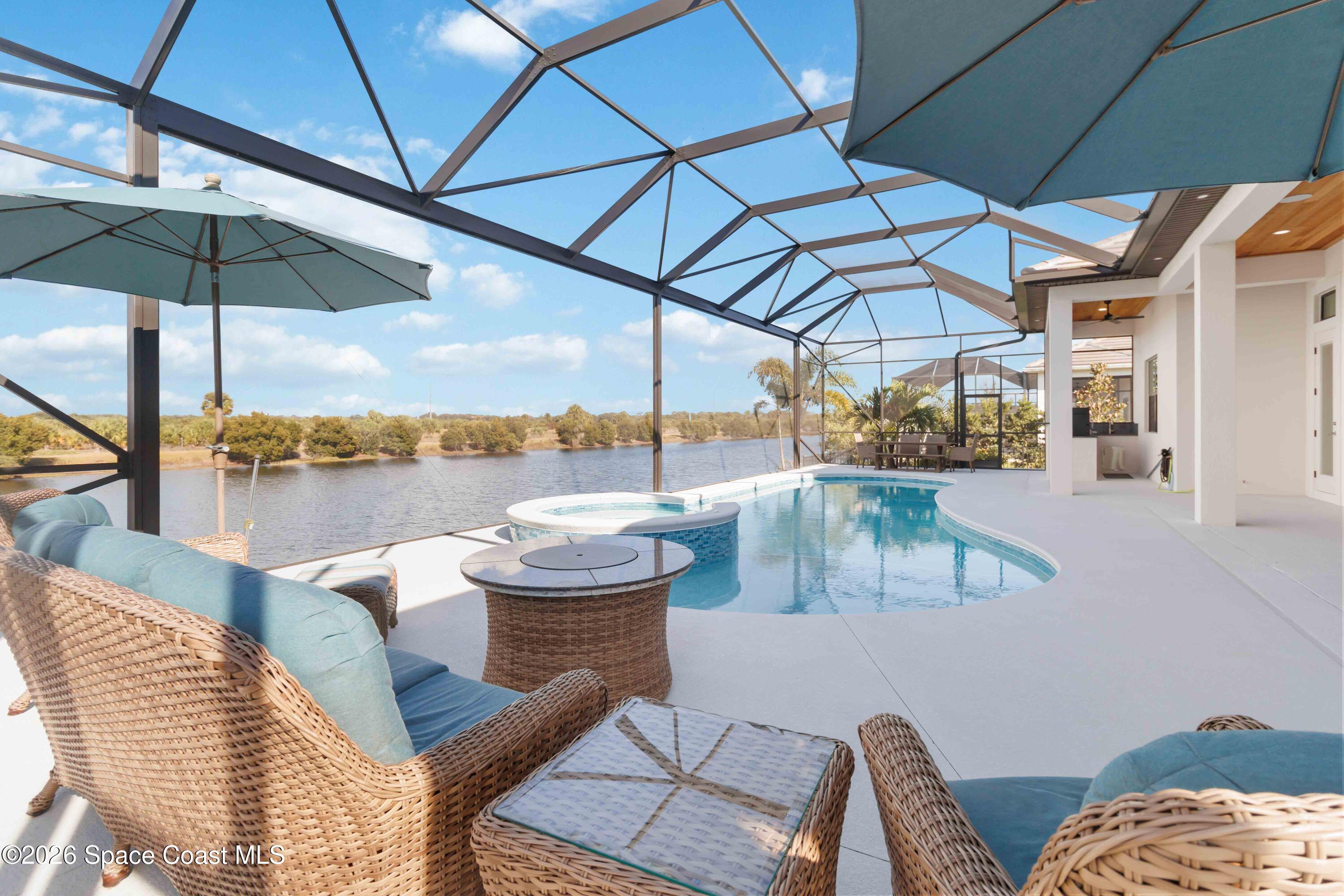4100 Domain Court Melbourne, FL 32934 - Photo 46 of 52 a view of a roof deck with couches under an umbrella