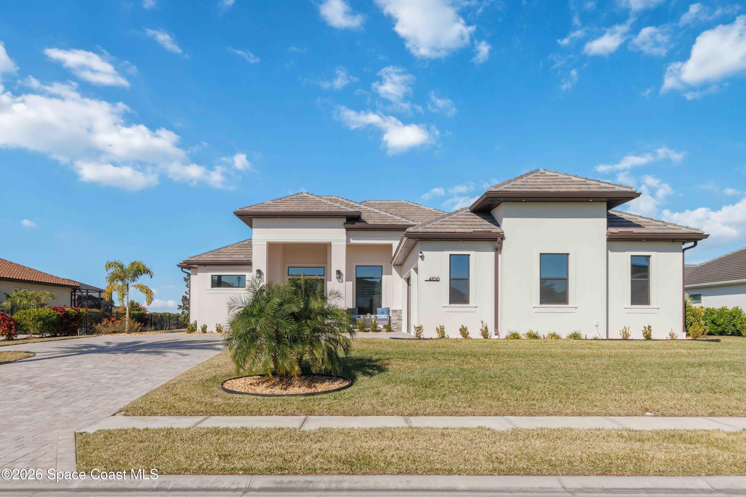4100 Domain Court Melbourne, FL 32934 - Photo 5 of 52 a front view of a house with a yard