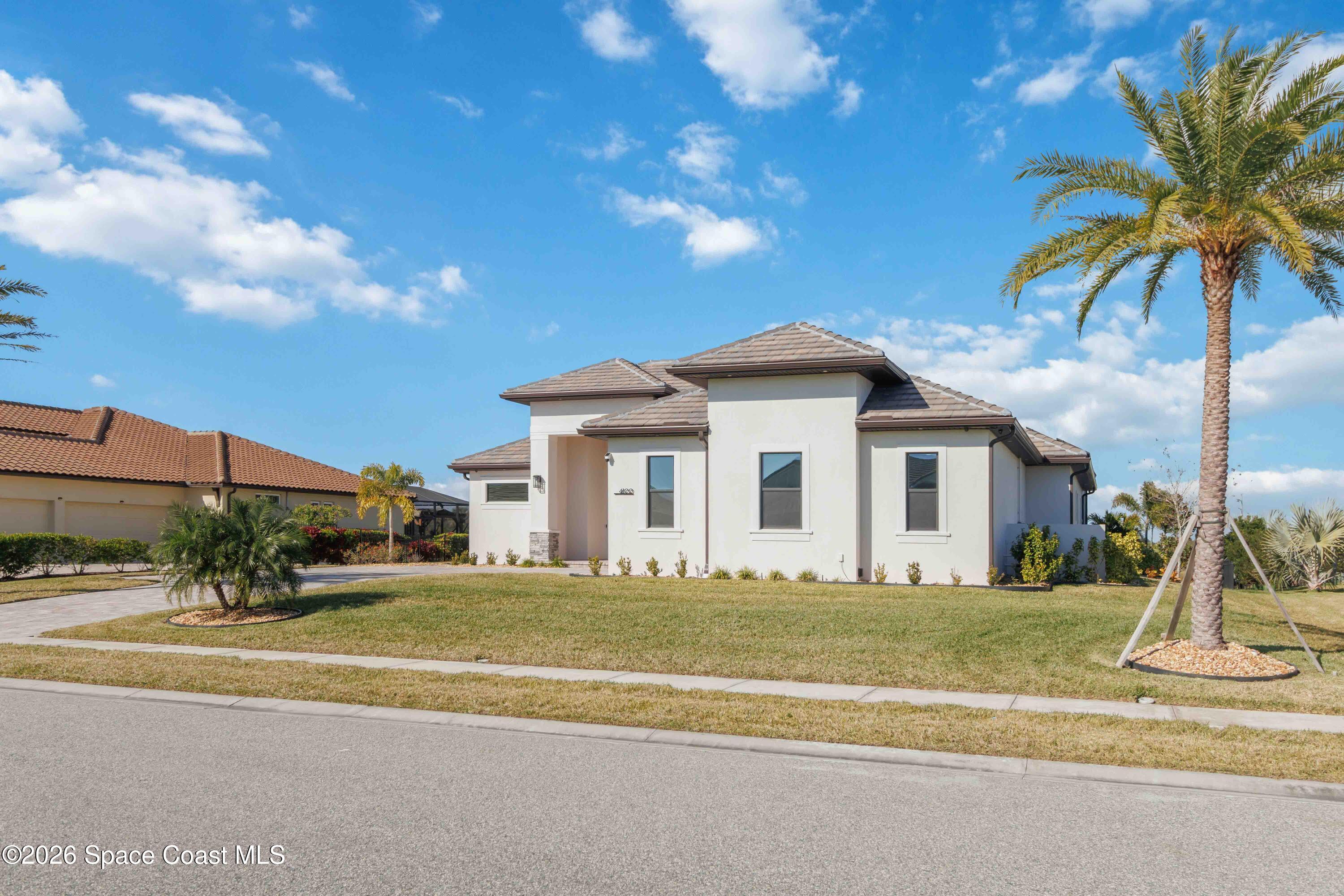 4100 Domain Court Melbourne, FL 32934 - Photo 6 of 52 a front view of a house with a yard