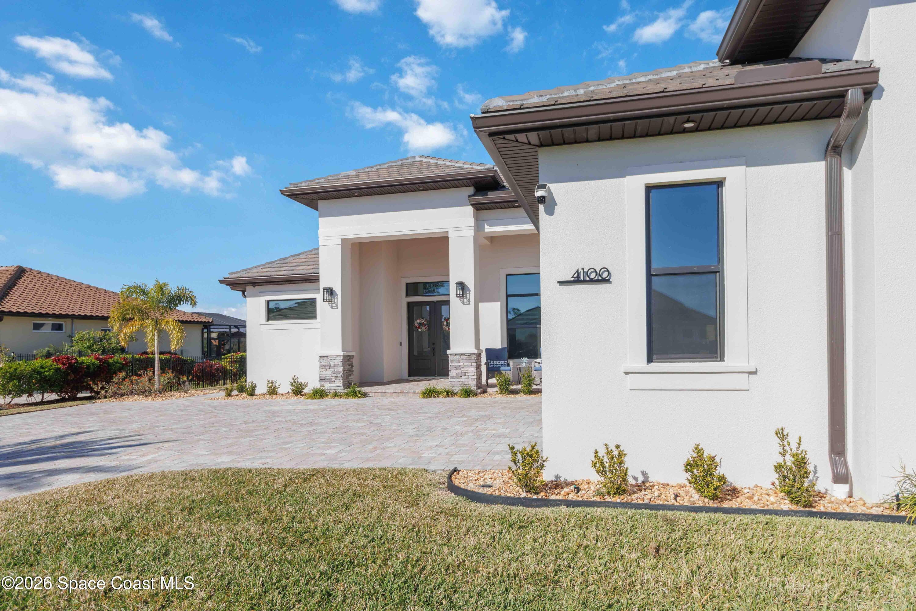 4100 Domain Court Melbourne, FL 32934 - Photo 7 of 52 a front view of a house with a yard