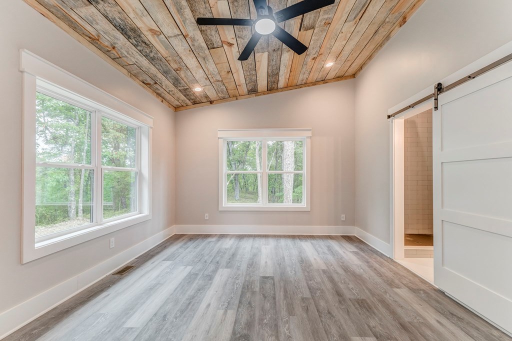 182 Stirratt Road Ranger, GA 30734 - Photo 37 of 82 a view of an empty room with wooden floor and a window