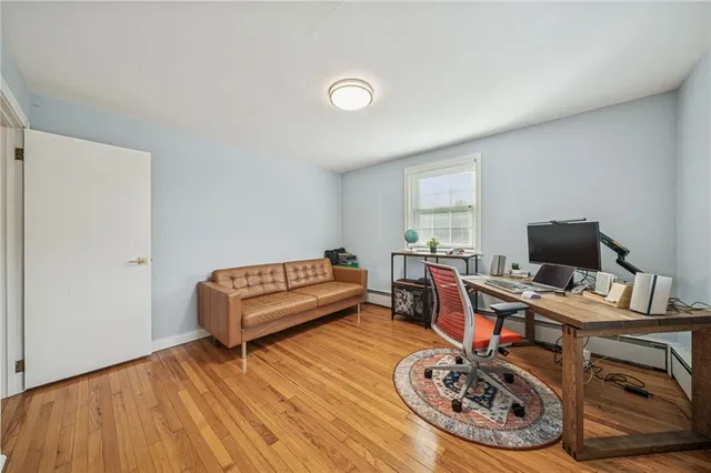 a view of a workspace with furniture and wooden floor