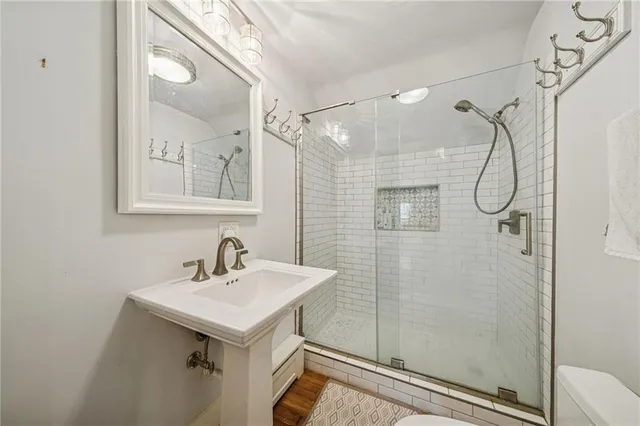 a bathroom with a sink mirror and shower