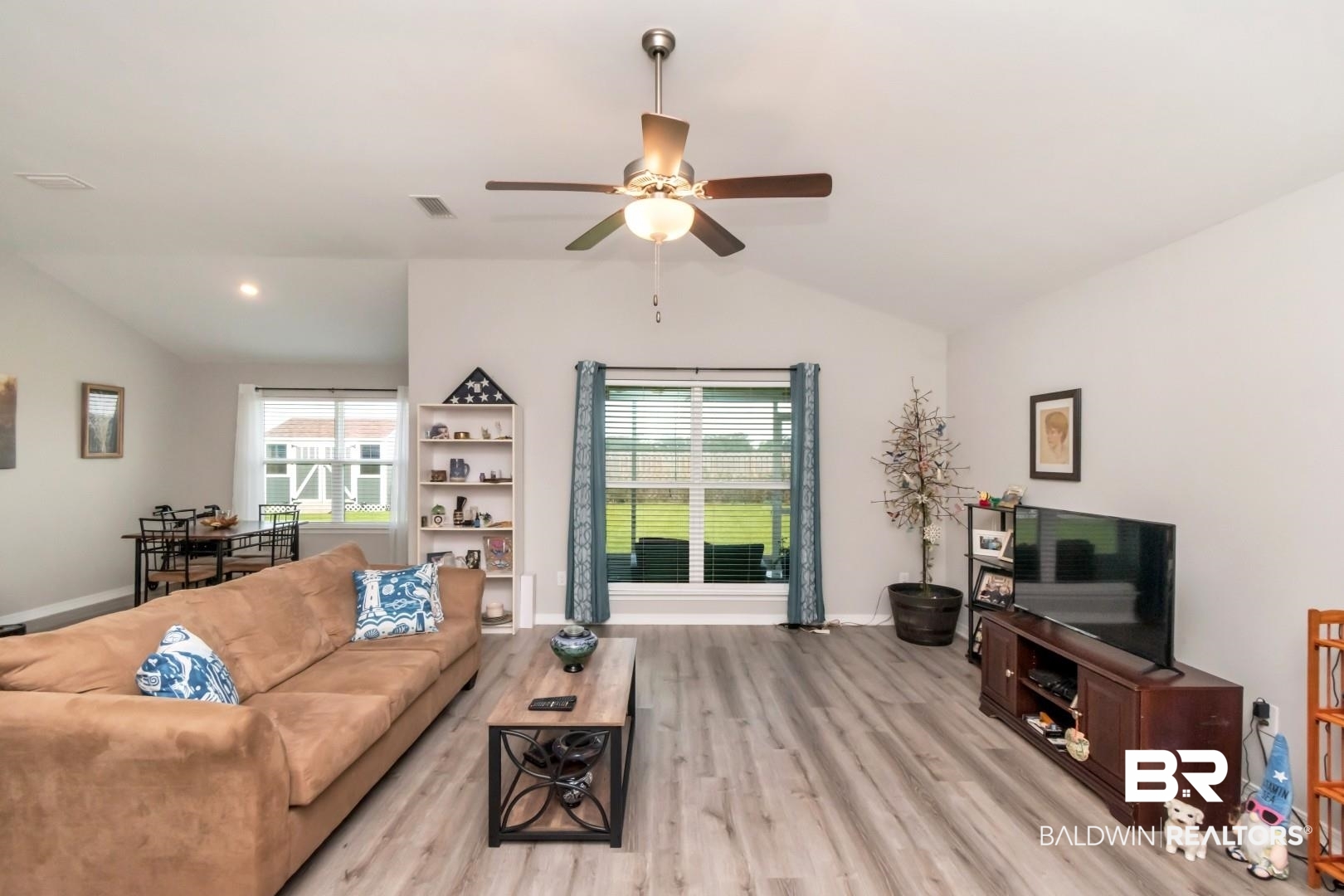 1295 Hayward Loop Foley, AL 36535 - Photo 7 of 29 Spacious living area featuring vaulted ceilings, wood-finish flooring, and a ceiling fan