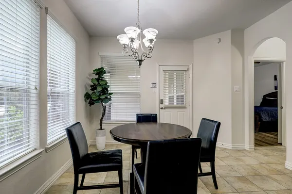 a dining room with furniture and chandelier