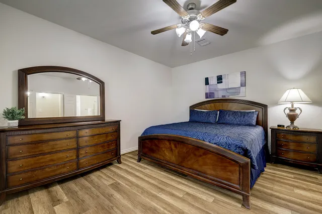 a bedroom with a bed and a chandelier