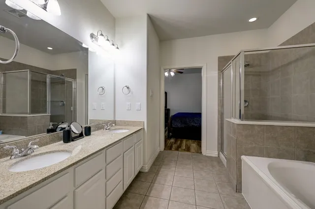 a bathroom with a tub sink and mirror