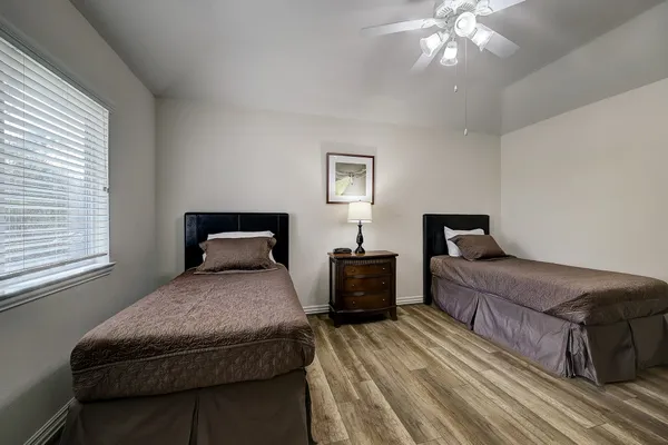 a bedroom with a large bed and a chandelier