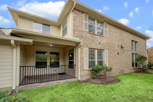 a view of a house with a small yard and flower plants