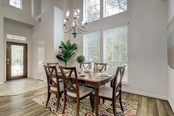 a view of a dining room with furniture and chandelier