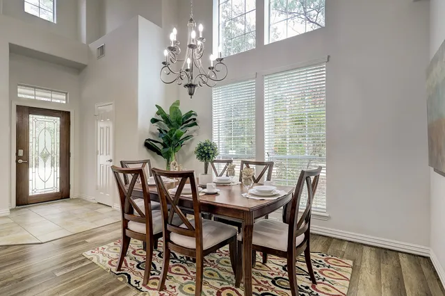 a view of a dining room with furniture and chandelier