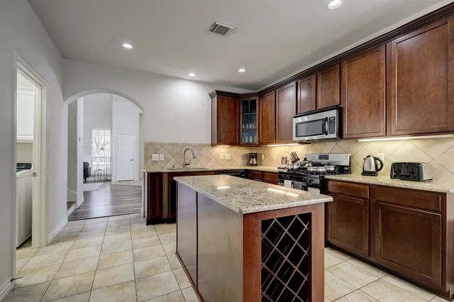a kitchen with a stove sink and cabinets