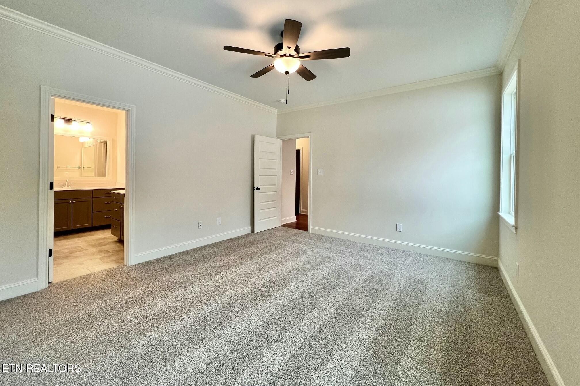 1228 Madison Oaks Road Knoxville, TN 37924 - Photo 14 of 33 a view of a livingroom with a ceiling fan a flat screen tv and a ceiling fan