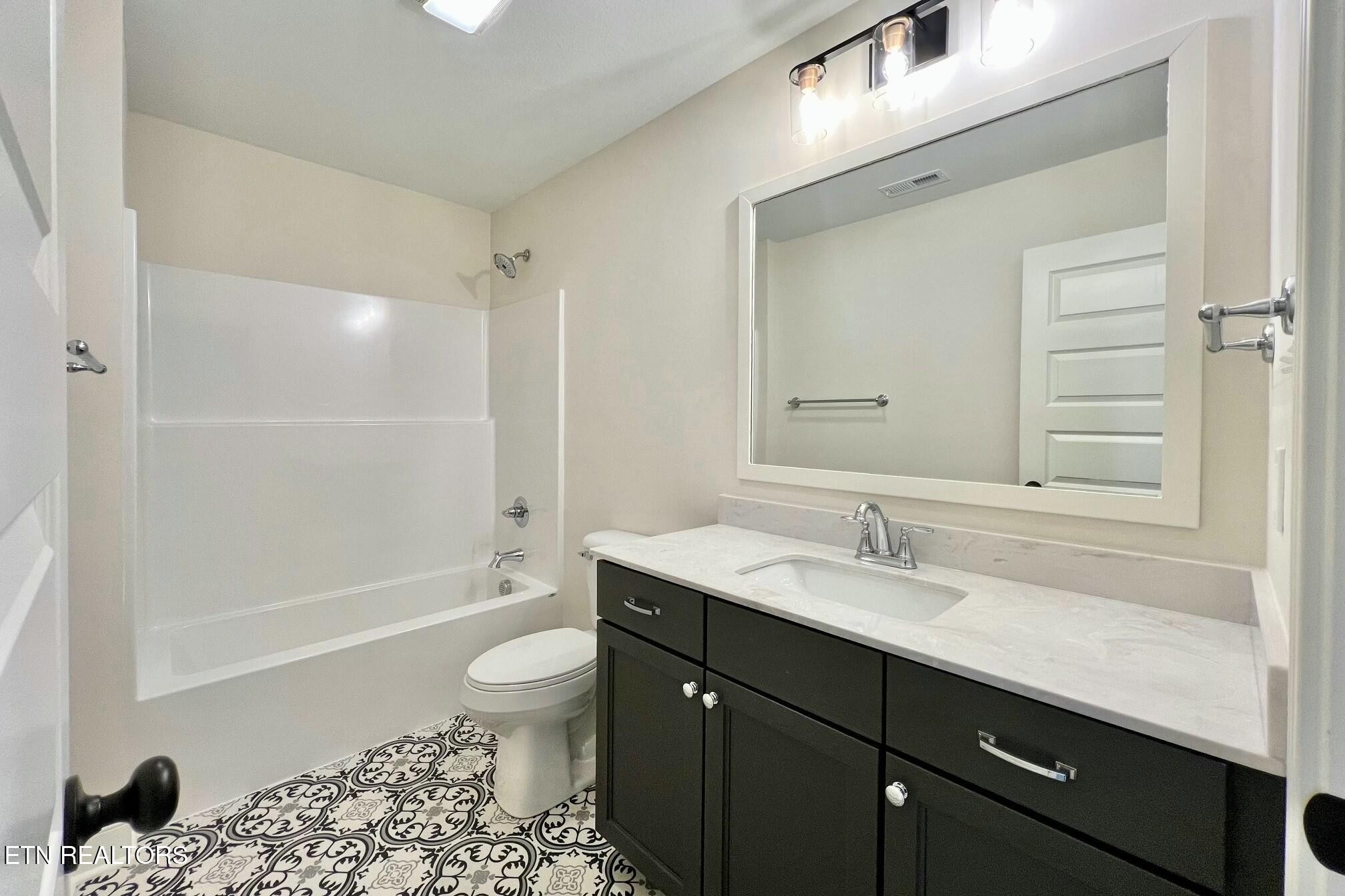 1228 Madison Oaks Road Knoxville, TN 37924 - Photo 27 of 33 a bathroom with a sink a toilet and shower