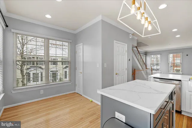 a kitchen with a table chairs and a window