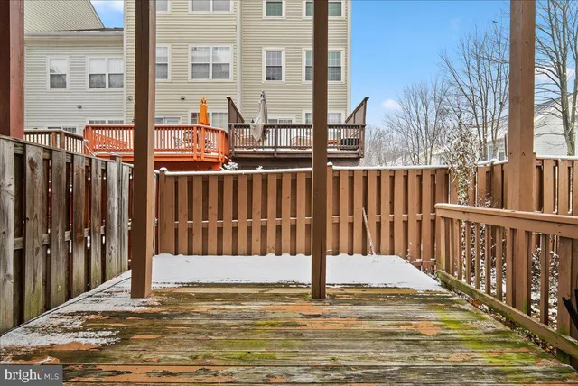 a view of a balcony with wooden floor and fence