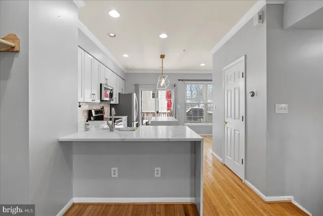 a kitchen with kitchen island a sink and a refrigerator