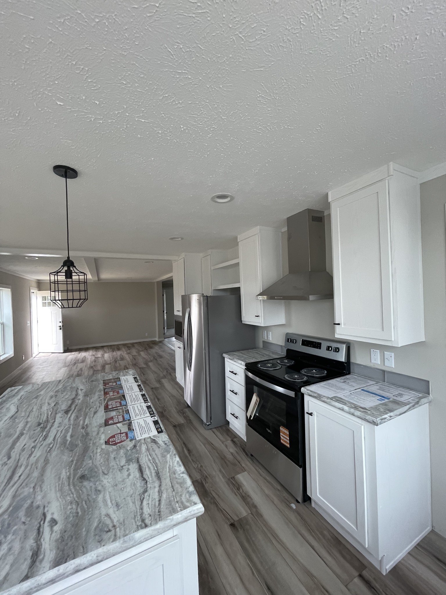881 White Springs Road Lafayette, TN 37083 - Photo 2 of 16 a kitchen with stainless steel appliances granite countertop a stove a sink and a refrigerator