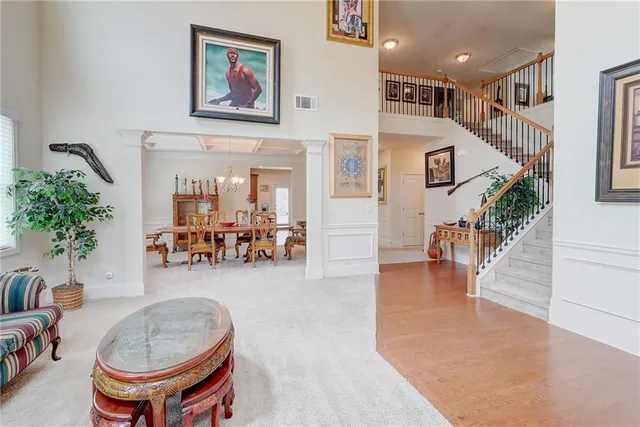 a living room with furniture and a ceiling fan