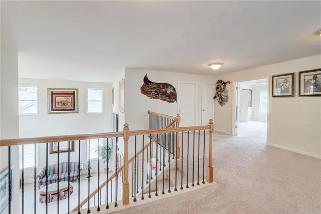 a living room with a bed furniture and a ceiling fan