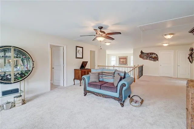 a spacious bedroom with a bed dresser and a chandelier