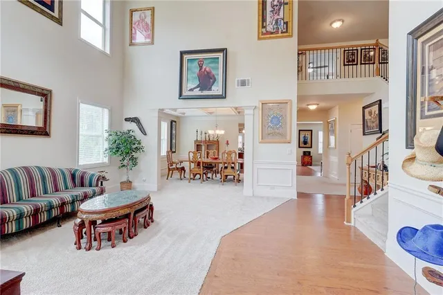 a living room with furniture and a book shelf