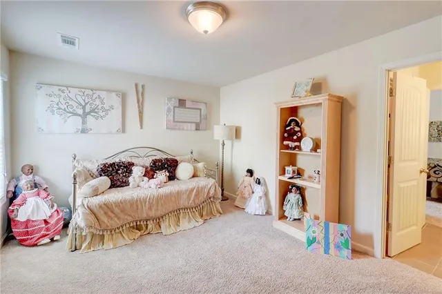 a bedroom with a bed couch and a window