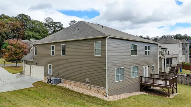 a aerial view of a house with swimming pool lawn chairs and a yard